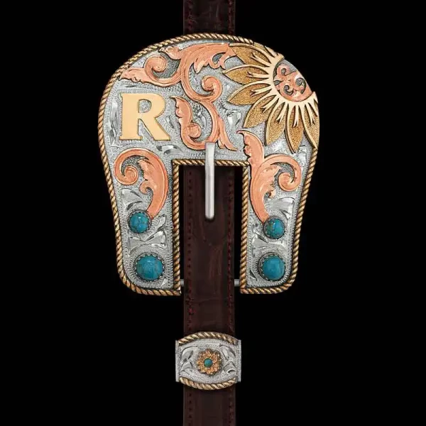 Our Lustiano Headstall Buckle radiates beauty on every detail. Hand crafted on a German Silver base, it features a Jeweler's Bronze rope edge, an initial and a sunflower on the top right corner. Adding extra western flair are the hand-engraved Copper scro